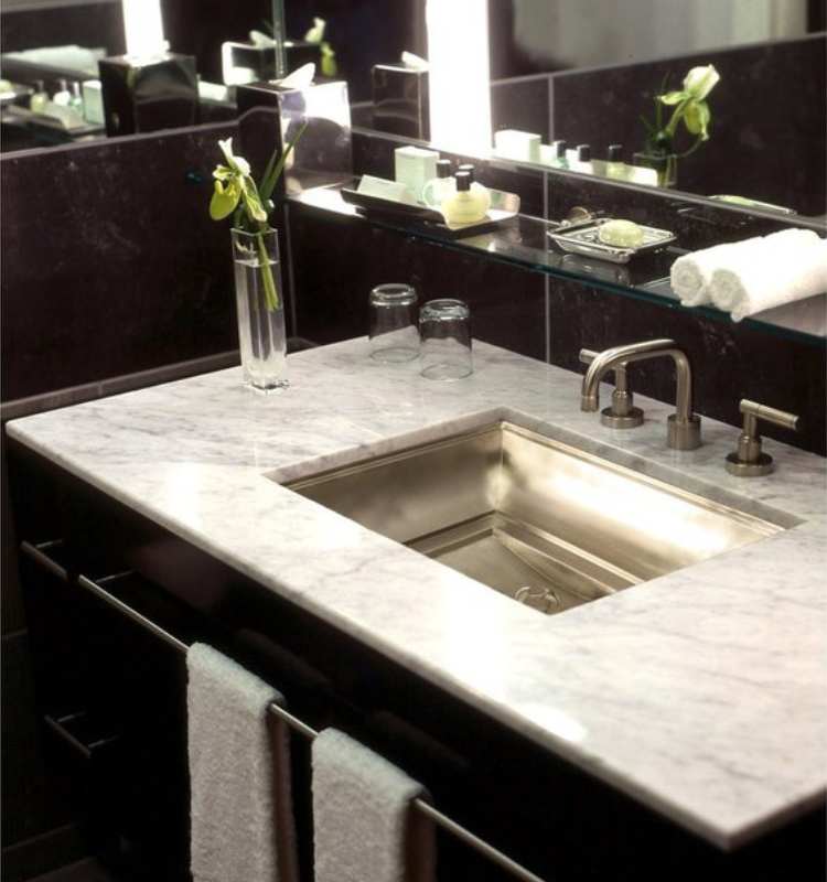 marble bathroom sink with black cabinets
